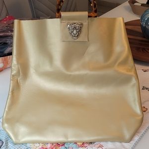 Leather handbag with vintage handle and recycled brooch.